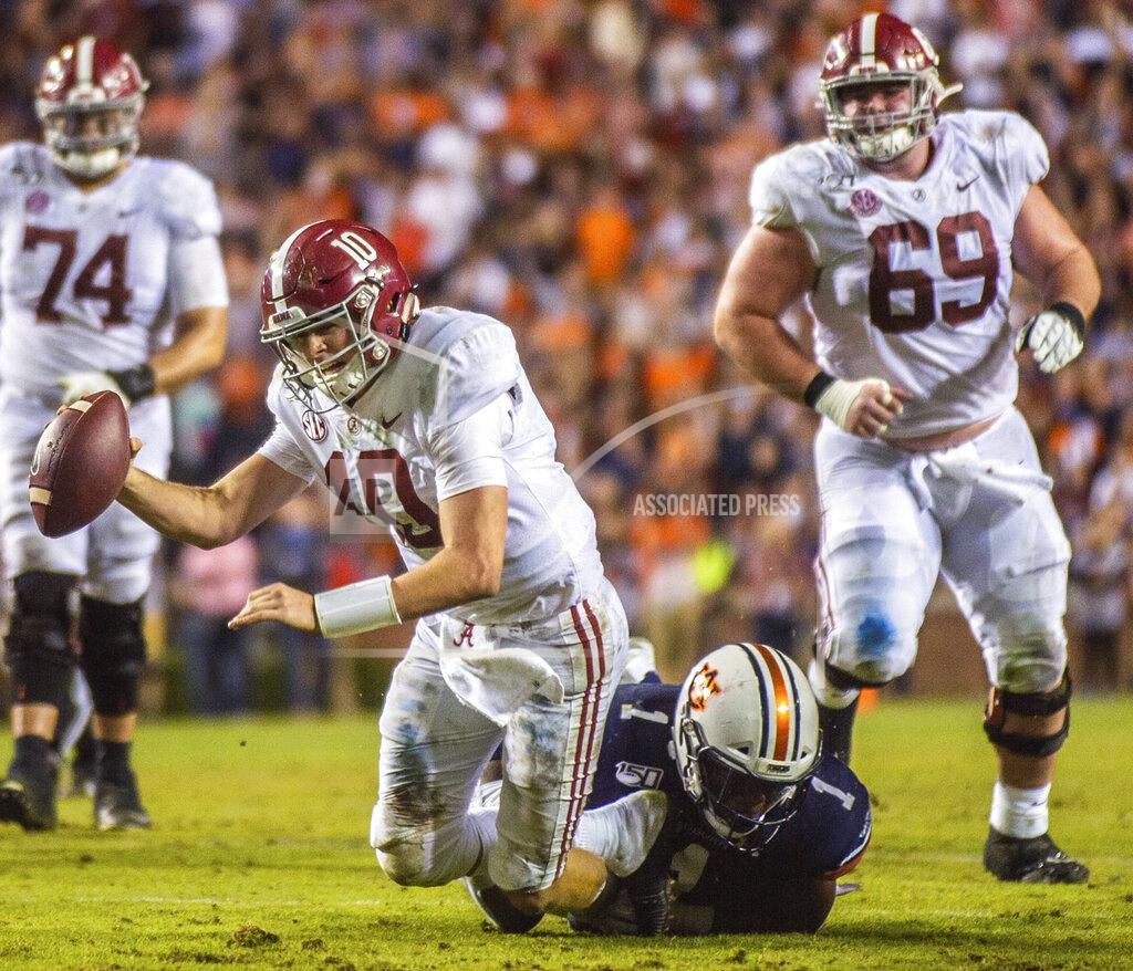 Alabama quarterback Mac Jones (10) is sacked by Auburn defensive end Big Kat Bryant (1) during the second half of an NCAA college football game Saturday, Nov. 30, 2019, in Auburn, Ala. (Dan Busey/The Decatur Daily via AP)