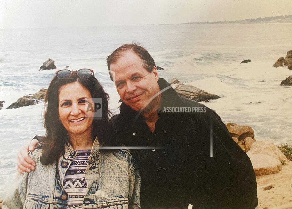 Uncredited Associated Press journalist Sharon Cohen and her partner, Mike Robinson, pose for a photo on the California coast in this undated photo. Cohen, a matchless reporter who told American stories with great skill and compassion over more than four decades at The AP, died Monday, April 5, 2021, at her Chicago home. She was 68. (Courtesy of Mike Robinson)