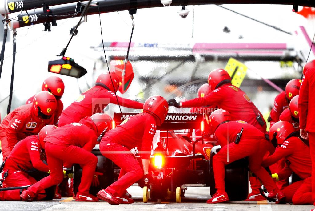 Pit crew work on the car of Ferrari driver Charles Leclerc of Monaco as he pulls into the pits during the Formula One pre-season testing session at the Barcelona Catalunya racetrack in Montmelo, outside Barcelona, Spain, Friday, Feb. 28, 2020. (AP Photo/Joan Monfort)