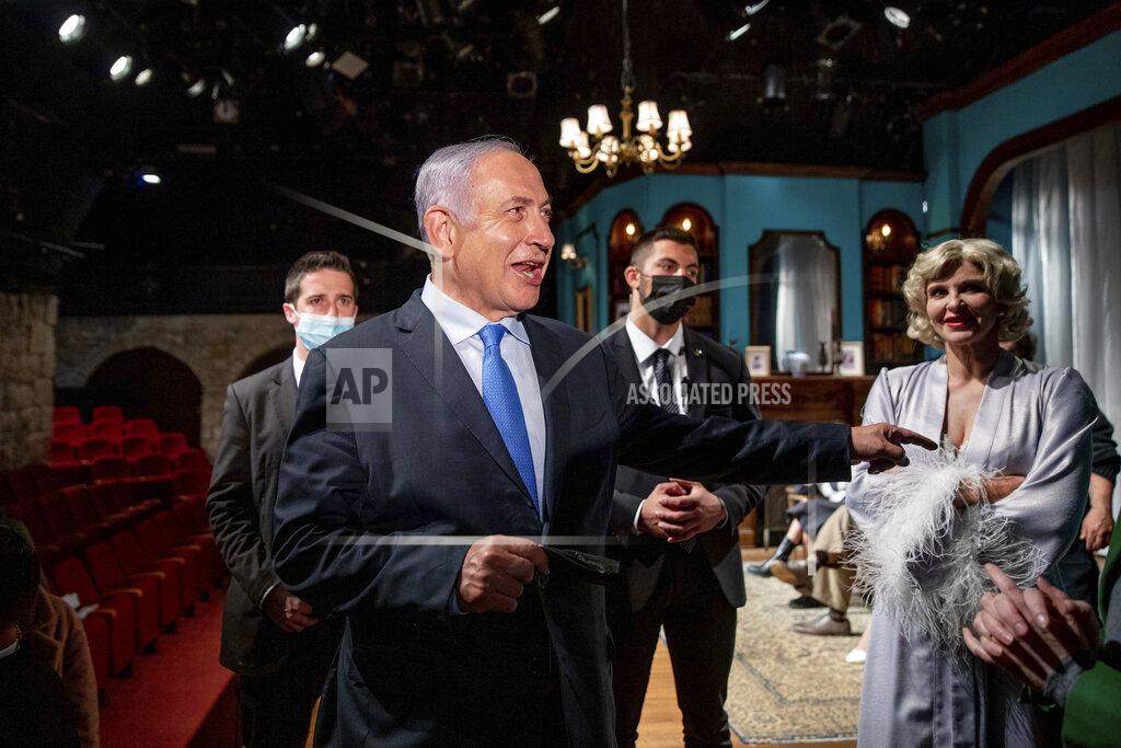 Ohad Zwigenberg Israeli Prime Minister Benjamin Netanyahu meets Israeli actress Carmit Mesilati Kaplan, right, during a visit to the Khan theater ahead of the re-opening of the culture sector, in Jerusalem on Tuesday, Feb. 23, 2021. (Ohad Zwigenberg/Pool Photo via AP)