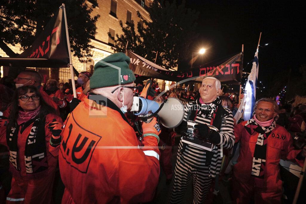 Sebastian Scheiner Israeli protesters chant slogans during a demonstration against Israeli Prime Minister Benjamin Netanyahu In Jerusalem, Saturday, Jan. 23, 2021. (AP Photo/Sebastian Scheiner)