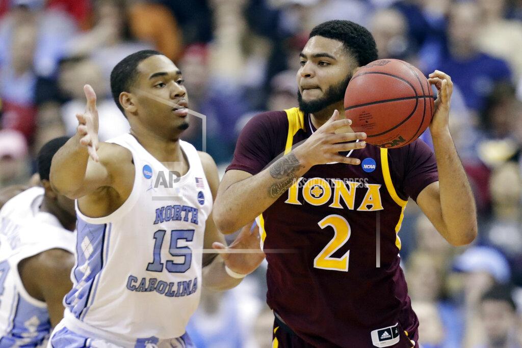 Tony Dejak Iona's E.J. Crawford (2) looks to pass against North Carolina's Garrison Brooks (15) in the first half during a first round men's college basketball game in the NCAA Tournament in Columbus, Ohio, Friday, March 22, 2019. (AP Photo/Tony Dejak)