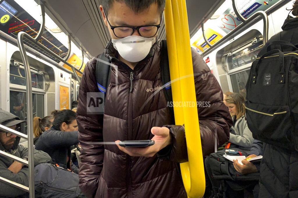 Wong Maye-E FILE0 In this March 12, 2020 file photo, a commuter wears a mask while riding the subway in the Brooklyn borough of New York. Commuters who refuse to wear a mask on New York City subways, trains and buses could face a $50 fine starting Monday, Sept. 14, 2020. (AP Photo/Wong Maye-E, File)