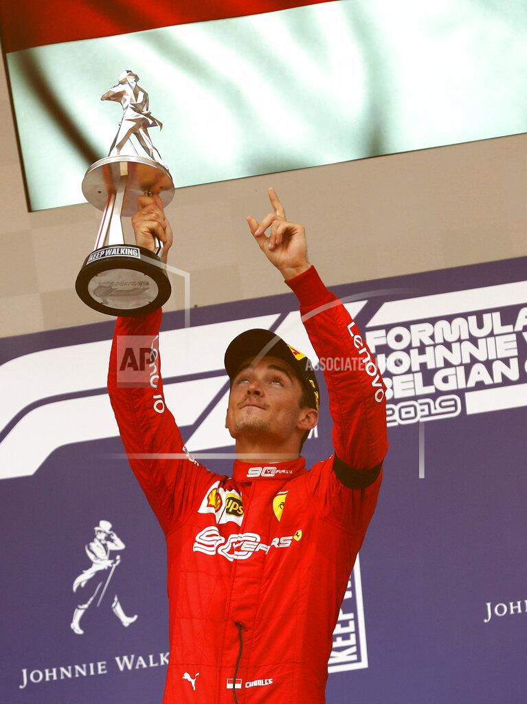Francisco Seco Ferrari driver Charles Leclerc of Monaco lifts the trophy after finishing first in the Belgian Formula One Grand Prix in Spa-Francorchamps, Belgium, Sunday, Sept. 1, 2019. Mercedes driver Lewis Hamilton of Britain placed second and Mercedes driver Valtteri Bottas of Finland placed third. (AP Photo/Francisco Seco)