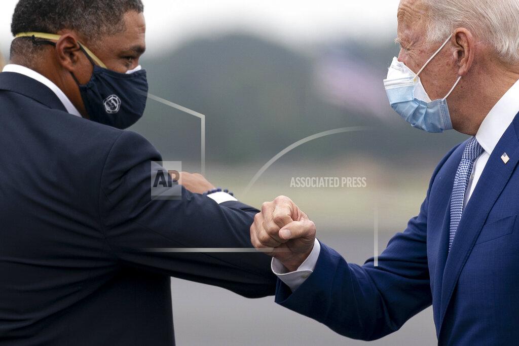 Andrew Harnik Democratic presidential candidate former Vice President Joe Biden greets Rep. Cedric Richmond, D-La., left, as he arrives at Columbus Airport in Columbus, Ga., Tuesday, Oct. 27, 2020, to travel to Warm Springs, Ga. for a rally. (AP Photo/Andrew Harnik)