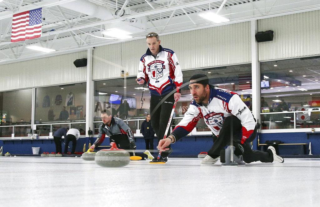Jim Mone In this Jan. 3, 2019 photo, former Minnesota Vikings football player Jared Allen, right, practices with his curling team for a competition as coach and former Olympian John Benton watches in Blaine, Minn. Allen retired from the NFL in 2015 and wasn't ready to give up on the competition he'd come to enjoy as a five-time All-Pro in a 12-year career. His solution: Make it to the 2022 Olympics _ in curling. Less than a year later, he and three other former NFL players who have never curled before will attempt to qualify for the U.S. championships against curlers who have been throwing stones for most of their lives. (AP Photo/Jim Mone)