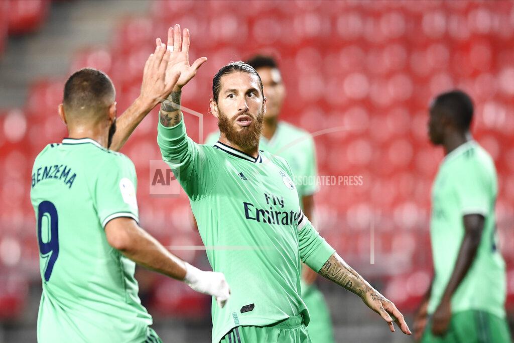 Jose Breton Real Madrid's Sergio Ramos, center, gestures with his teammate Benzema during the Spanish La Liga soccer match between Granada and Real Madrid at the Los Carmenes stadium in Granada, Spain, Monday, July 13, 2020. (AP Photo/Jose Breton)