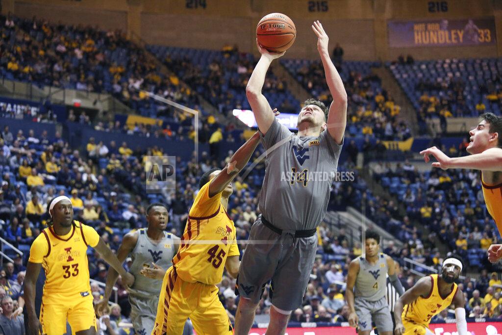 Kathleen Batten West Virginia guard Chase Harler (14) shoots as he is defended by Iowa State guard Rasir Bolton (45) during the second half of an NCAA college basketball game Wednesday, Feb. 5, 2020, in Morgantown, W.Va. (AP Photo/Kathleen Batten)