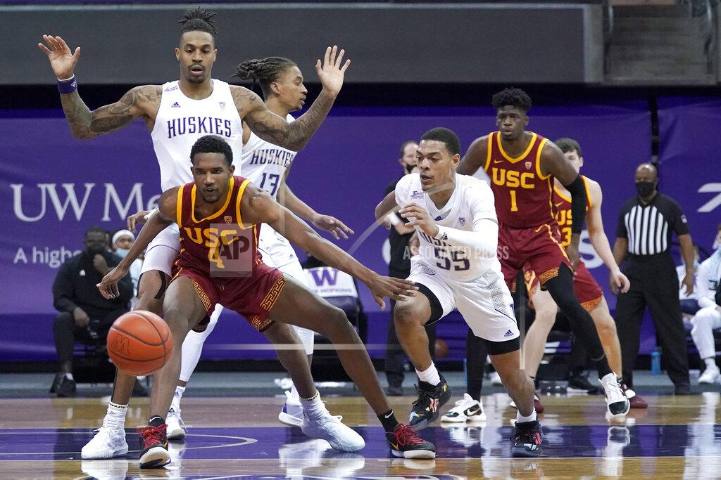 Ted S. Warren Southern California forward Evan Mobley (4) and Washington guard Quade Green (55) eye a loose ball during the first half of an NCAA college basketball game Thursday, Feb. 11, 2021, in Seattle. (AP Photo/Ted S. Warren)