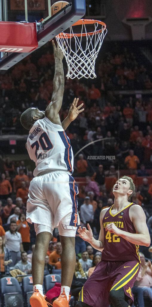 Rick Danzl Illinois guard Da'Monte Williams (20) gets a tap-in basket over Minnesota forward Michael Hurt (42) during the first half of an NCAA college basketball game in Champaign, Ill., Wednesday, Jan. 16, 2019. (AP Photo/Rick Danzl)