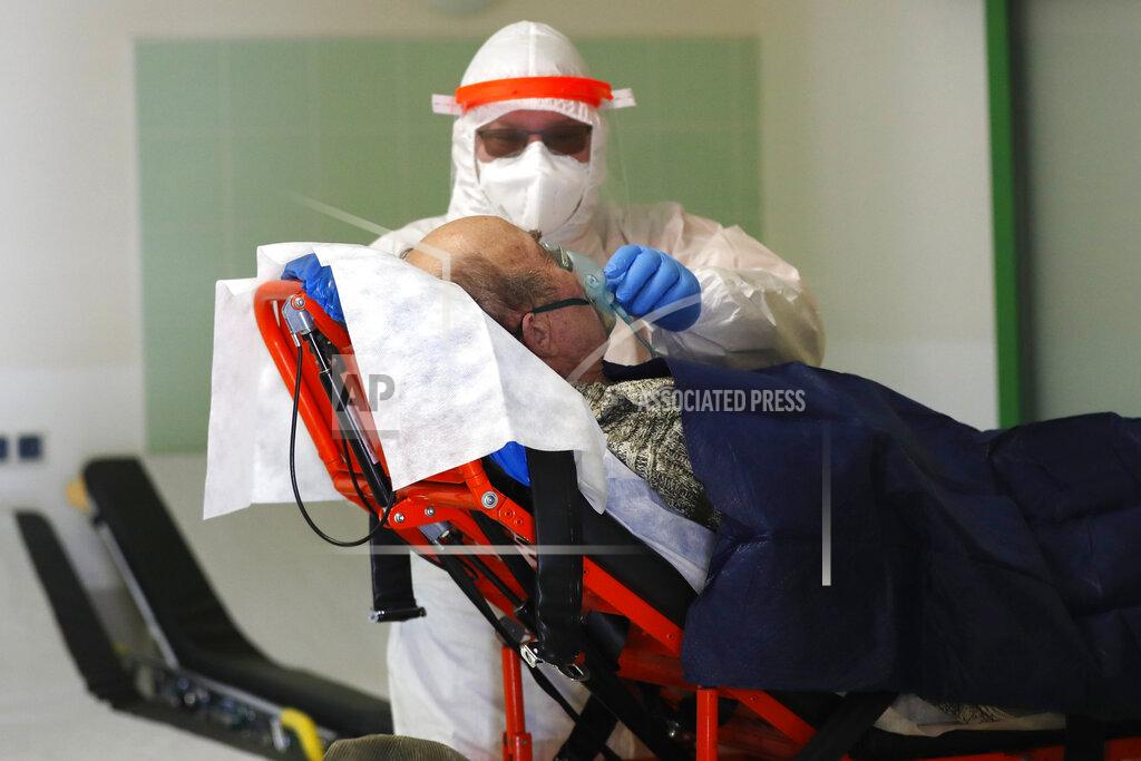 Petr David Josek Medical worker attends to a covid-19 patient at a hospital overrun by the covid pandemic in Cheb, Czech Republic, Friday, Feb. 12, 2021. The Czech government has imposed a complete lockdown of the three hardest-hit counties to help contain the spread of a highly contagious variant of the coronavirus. The meeasures will became effective Friday for the two counties in western Czech Republic on the German border Cheb and Sokolov and another county in the northern part of the country Trutnov located on the border with Poland. (AP Photo/Petr David Josek)