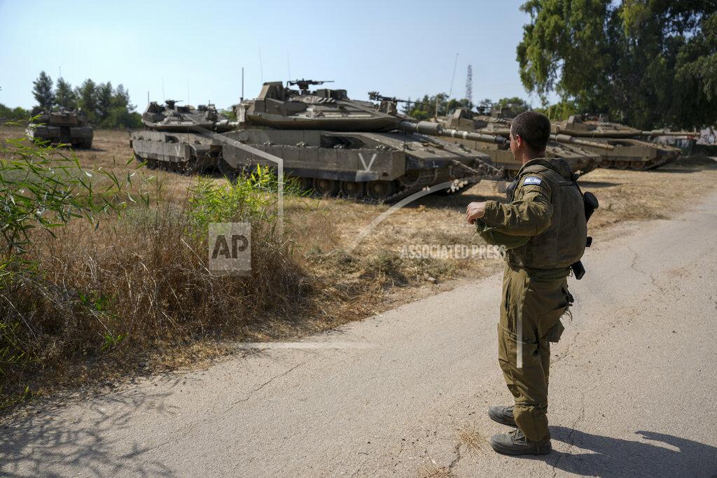 Ariel Schalit An Israeli soldier secures tanks in an area near the border with Gaza Strip, Friday, Aug. 5, 2022. Israel has closed roads near Gaza and sent in troop reinforcements as it braces for a possible revenge attack, following the arrest of a senior Palestinian militant in the occupied West Bank earlier this week. (AP Photo/Ariel Schalit)