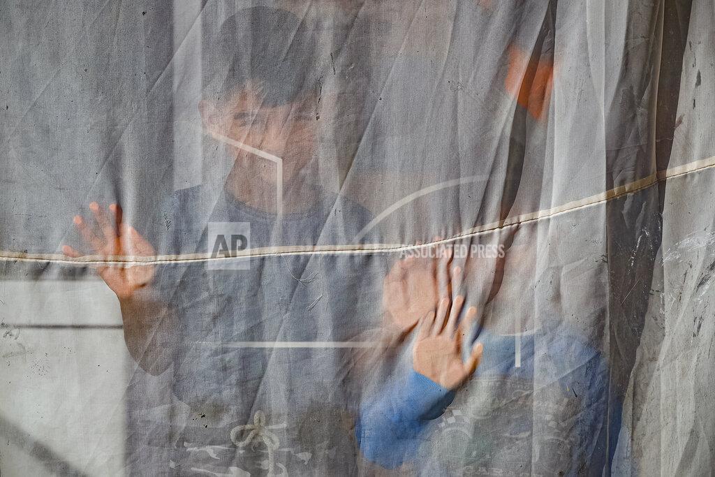 Vadim Ghirda Two young children, nephews of Azime Ali Topchu, 48, playfully pose for a photograph behind a curtain in a village on the outskirts of Burgas, Bulgaria, Monday, Sept. 28, 2020. (AP Photo/Vadim Ghirda)