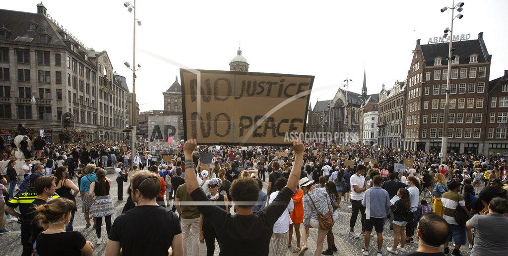 Peter Dejong People take part in a Black Lives Matter protest on Dam Square in Amsterdam, Netherlands, Monday, June 1, 2020, to protest against the recent killing of George Floyd, a black man who died in police custody in Minneapolis, U.S.A., after being restrained by police officers on Memorial Day. (AP Photo/Peter Dejong)