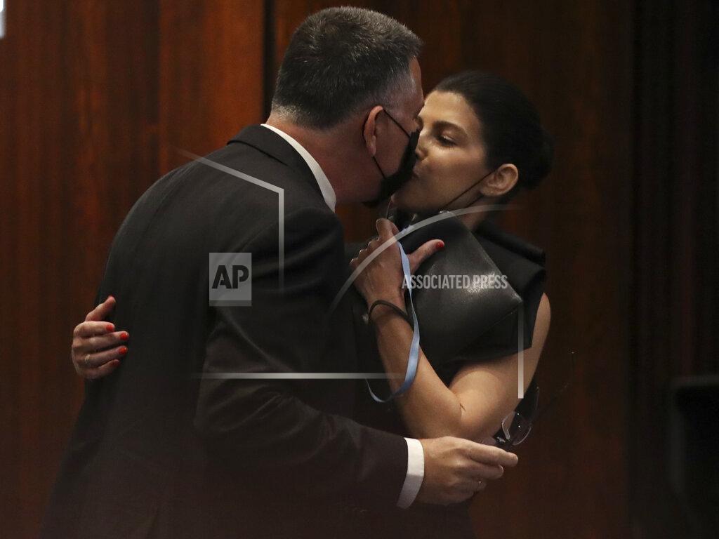 Ariel Schalit Israeli politician Gideon Saar of the New Hope party kisses his wife Geula Even-Saar during a Knesset session in Jerusalem Sunday, June 13, 2021. Naftali Bennett is expected later Sunday to be sworn in as the country's new prime minister, ending Prime Minister Benjamin Netanyahu's 12-year rule. (AP Photo/Ariel Schalit)