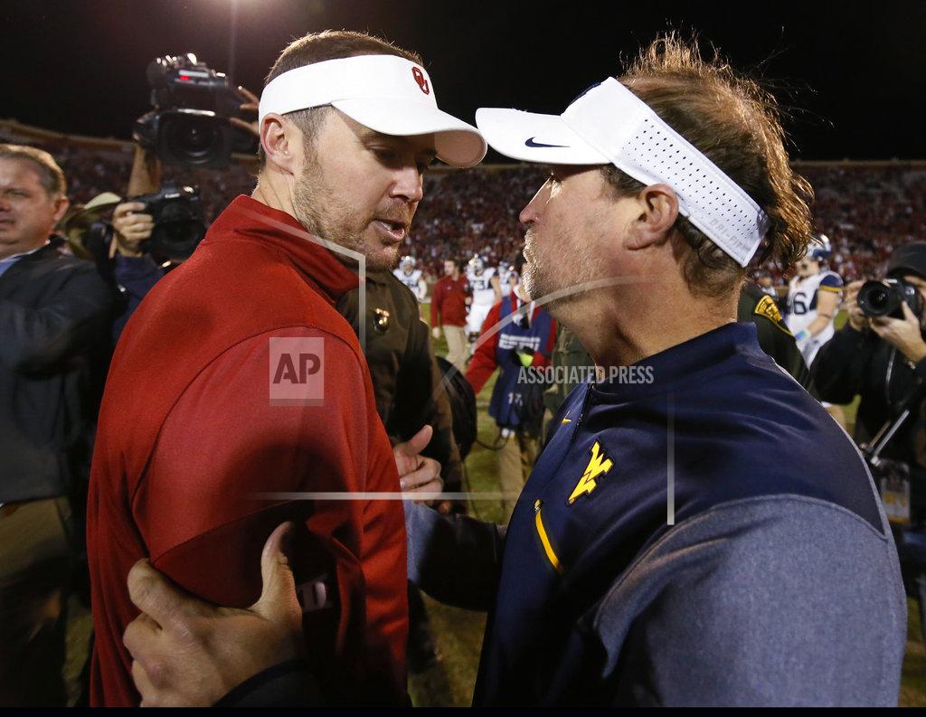 FILE - In this Nov. 25, 2017, file photo, Oklahoma head coach Lincoln Riley, left, and West Virginia head coach Dana Holgorsen, right, talk after their NCAA college football game in Norman, Okla. No. 6 Oklahoma or No. 7 West Virginia can get into the Big 12 championship game by winning their last two games. Since those Top 10 teams still have to play each other in the regular season, it is impossible for both to win their last two games. But the three-time defending Big 12 champion Sooners (9-1, 6-1 Big 12) and Mountaineers (8-1, 6-1) could also still face each other two weeks in a row _ in that day-after-Thanksgiving game in Morgantown, and then Dec. 1 for the conference title. (AP Photo/Sue Ogrocki, File)