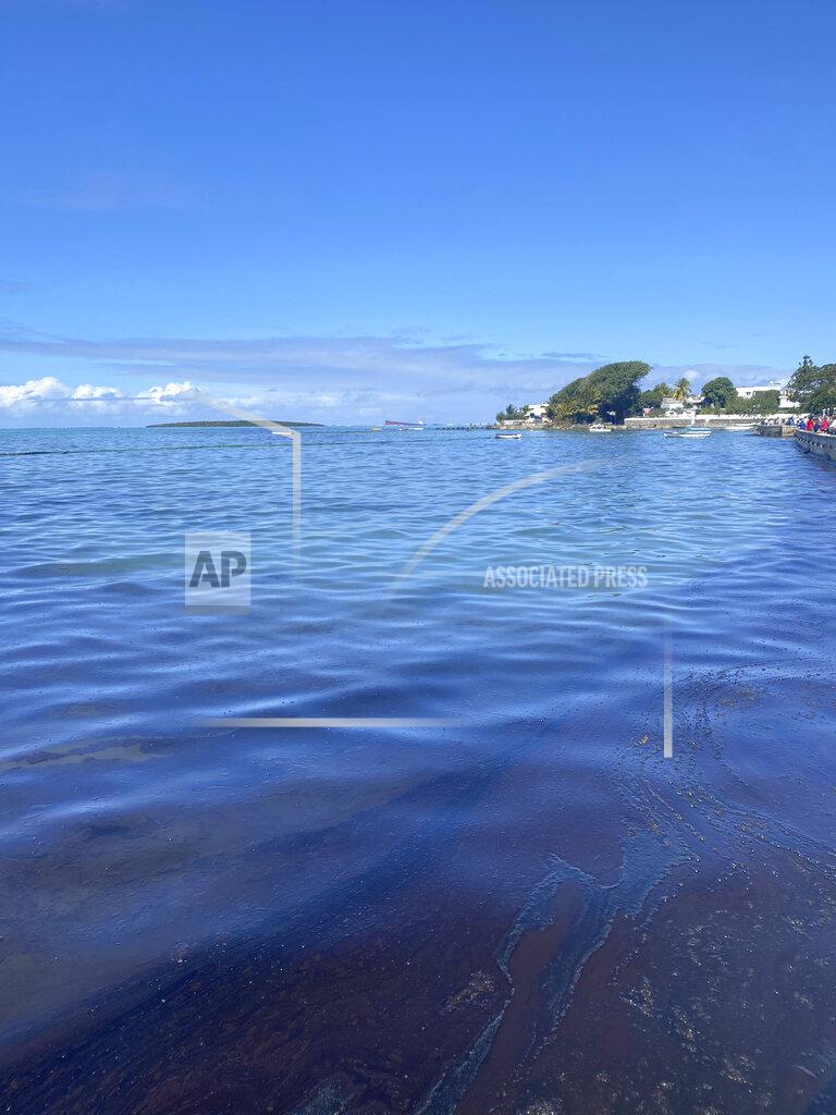 Uncredited In this photo provided by Grégoire Rouxel fuel is seen in the ocean from a ship, top right, that ran aground, Friday, Aug. 7, 2020, in Mauritius. The Indian Ocean island of Mauritius has declared a "state of environmental emergency" after a Japanese-owned ship that ran aground offshore days ago began spilling tons of fuel. Prime Minister Pravind Jugnauth announced the development late Friday, Aug. 7, as satellite images showed a dark slick spreading near environmental areas the government called "very sensitive." (@gregrouxel via AP)
