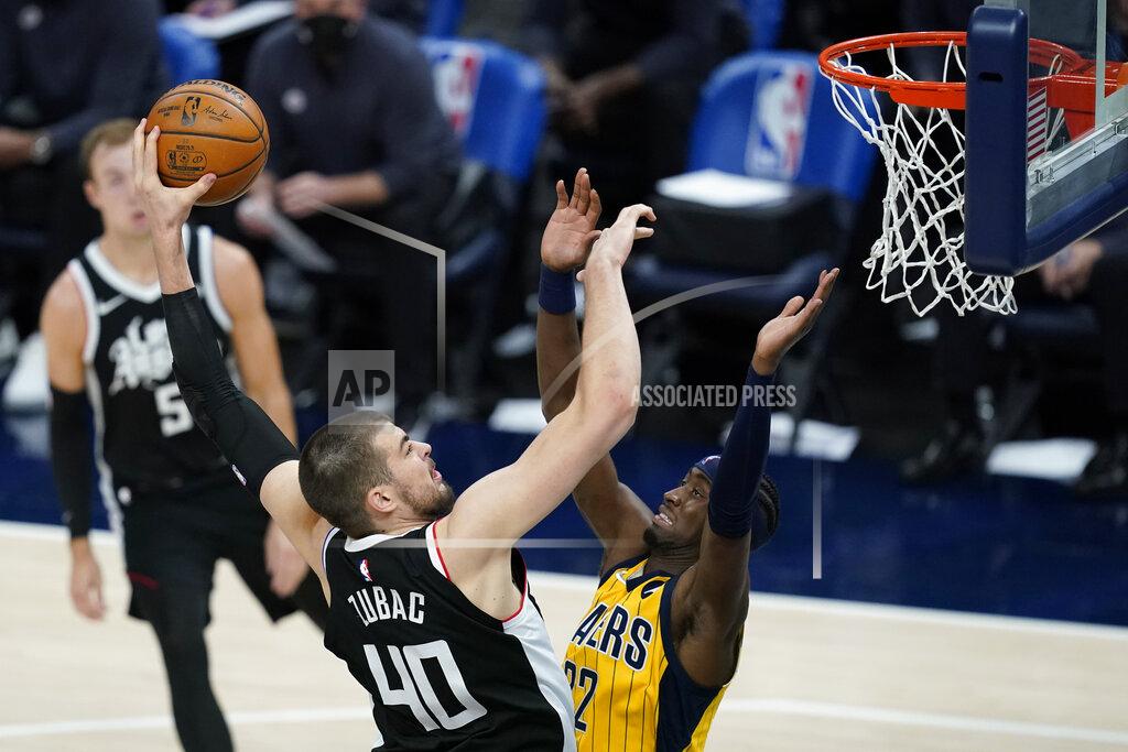 Darron Cummings Los Angeles Clippers' Ivica Zubac (40) dunks over Indiana Pacers' Caris LeVert (22) during the first half of an NBA basketball game, Tuesday, April 13, 2021, in Indianapolis. (AP Photo/Darron Cummings)