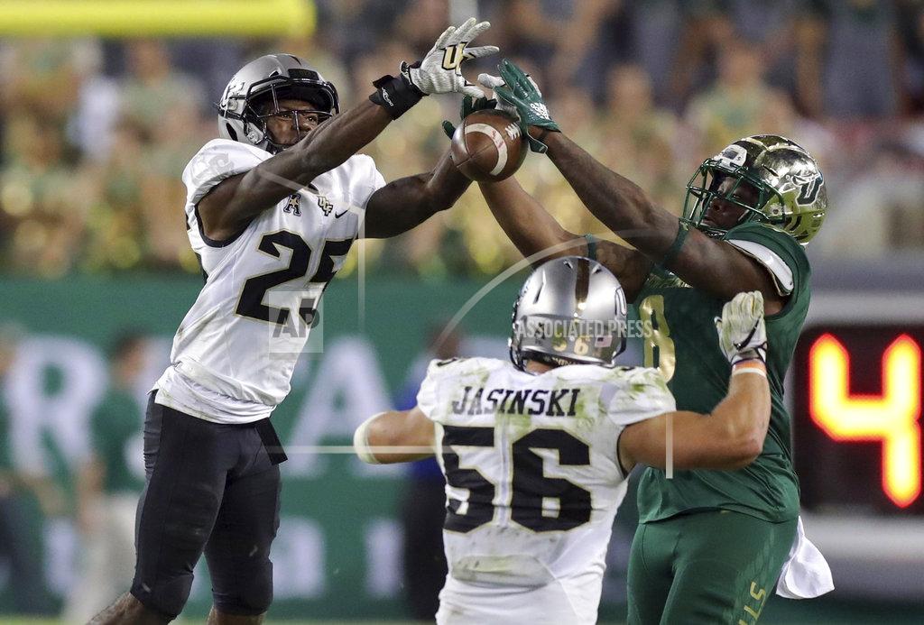 Mike Carlson Central Florida's Kyle Gibson (25) breaks up a pass intended for South Florida's Tyre McCants during the second half of an NCAA college football game Friday, Nov. 23, 2018, in Tampa, Fla. (AP Photo/Mike Carlson)