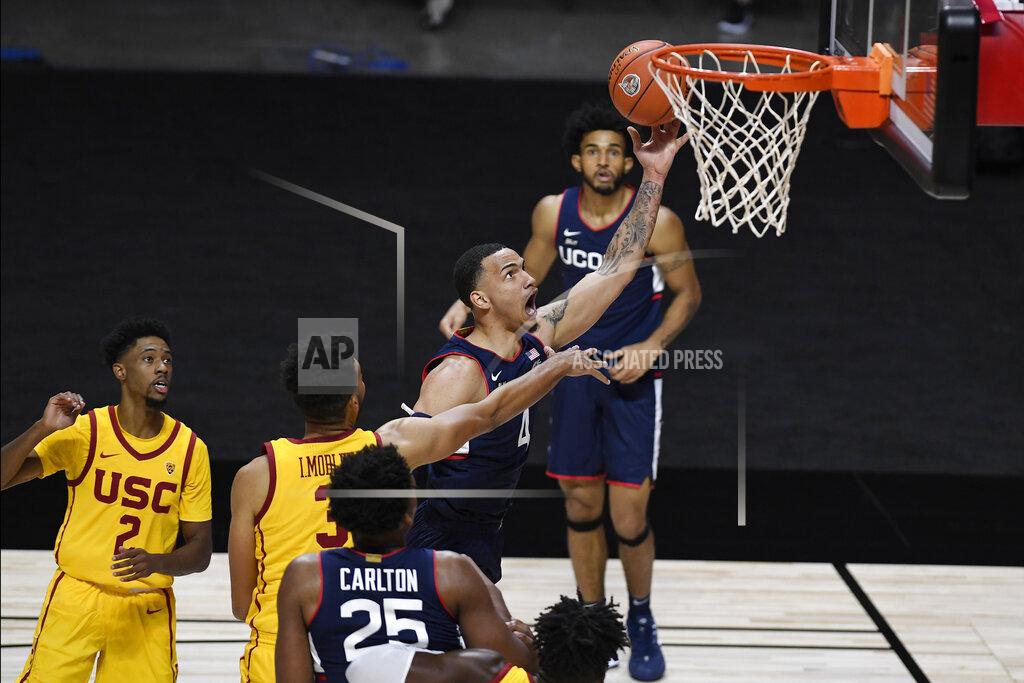 Jessica Hill Connecticut's Tyrese Martin goes up for a basket during the first half of the team's NCAA college basketball game against Southern California, Thursday, Dec. 3, 2020, in Uncasville, Conn. (AP Photo/Jessica Hill)