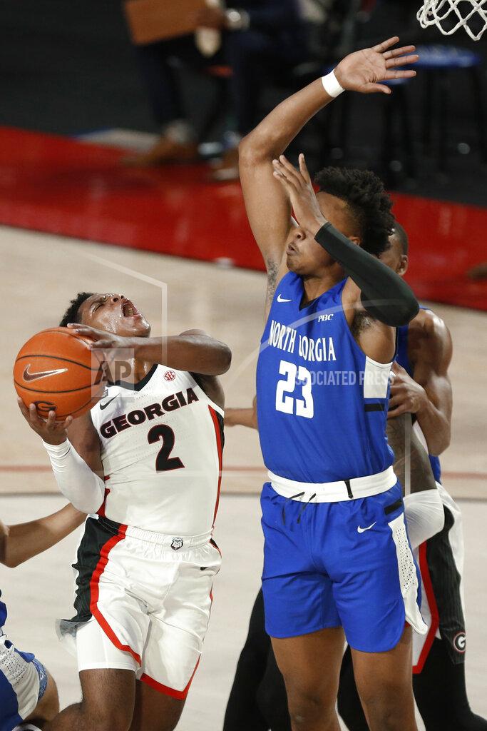 Joshua L. Jones Georgia's Sahvir Wheeler (2) shoots while being defended by North Georgia forward Frank Champion (23) during an NCAA college basketball exhibition game in Athens, Ga., Wednesday, Dec. 2, 2020. (Joshua L. Jones/Athens Banner-Herald via AP)