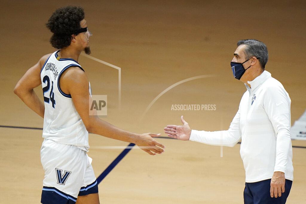 Matt Slocum Villanova's Jeremiah Robinson-Earl, left, and head coach Jay Wright celebrate during the second half of an NCAA college basketball game against Saint Joseph's, Saturday, Dec. 19, 2020, in Villanova, Pa. (AP Photo/Matt Slocum)