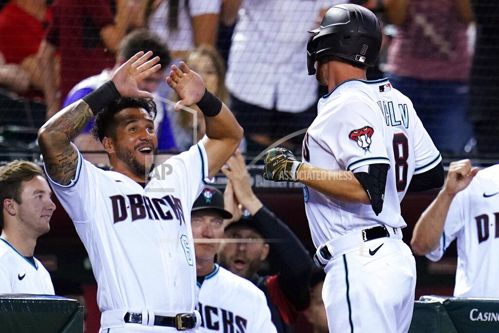 Ross D. Franklin Arizona Diamondbacks' Jordan Luplow (8) celebrates his three-run home run against the Kansas City Royals with Diamondbacks' David Peralta (6) during the sixth inning of a baseball game Tuesday, May 24, 2022, in Phoenix. (AP Photo/Ross D. Franklin)