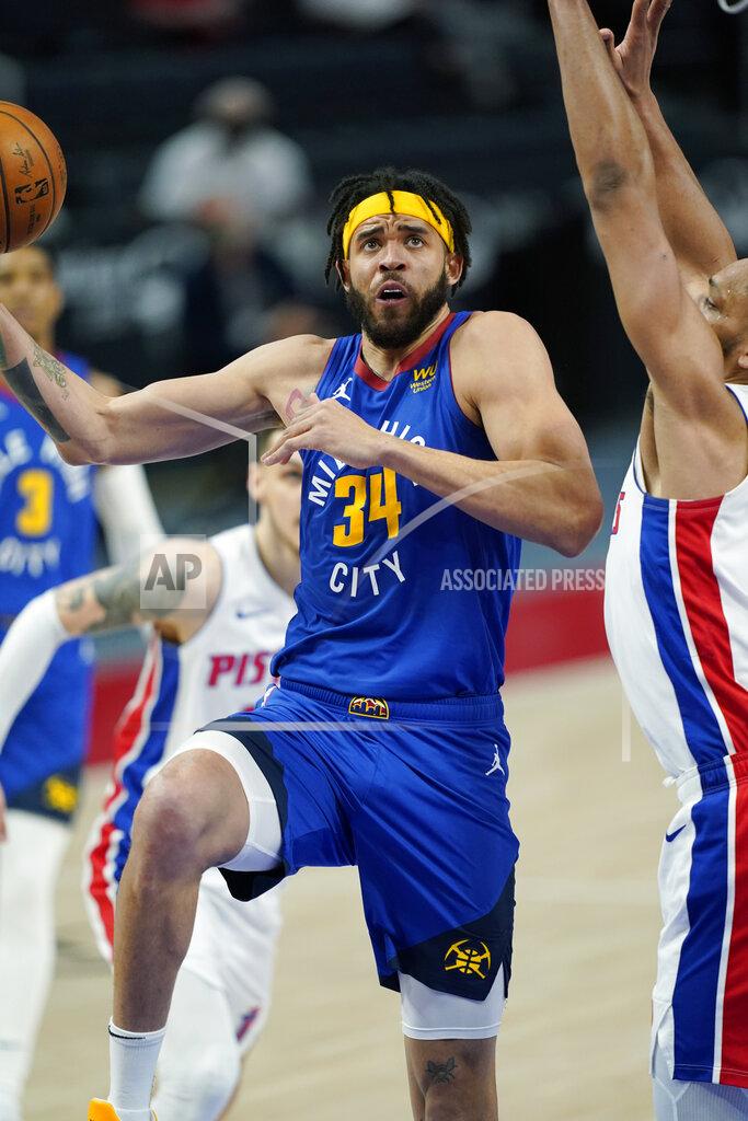 Carlos Osorio Denver Nuggets center JaVale McGee (34) makes a layup as Detroit Pistons center Jahlil Okafor defends during the first half of an NBA basketball game, Friday, May 14, 2021, in Detroit. (AP Photo/Carlos Osorio)