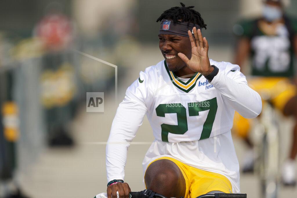 Matt Ludtke Green Bay Packers' running back Patrick Taylor rides a bicycle to NFL football training camp Saturday, July 31, 2021, in Green Bay, Wis. (AP Photo/Matt Ludtke)