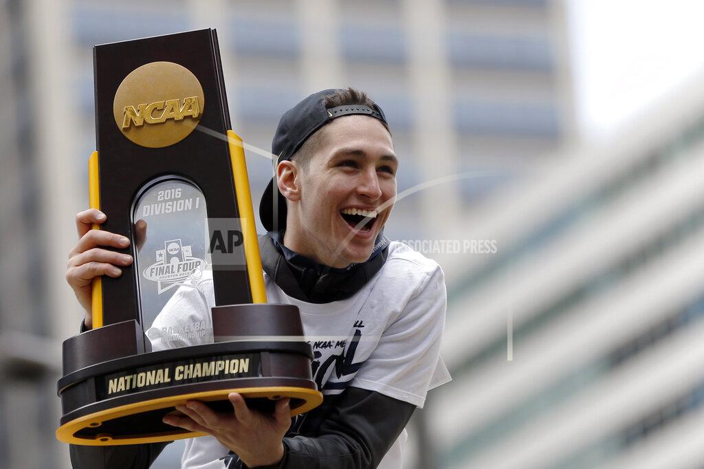 Matt Rourke FILE - In this Friday, April 8, 2016, file photo, Villanova's Ryan Arcidiacono holds the trophy during a parade celebrating their NCAA college men's basketball championship, in Philadelphia. The NCAA and networks across the sports dial have infused fans with a hoops fix by rebroadcasting epic NCAA Tournament games. Coaches and players involved in those games are adding insight and a dash of humor by live tweeting during the replay. (AP Photo/Matt Rourke, File)