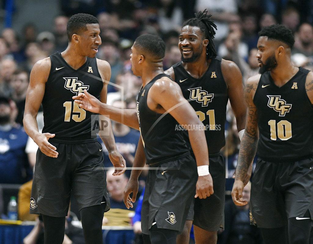 Jessica Hill Central Florida's Aubrey Dawkins (15) celebrates his basket with teammates BJ Taylor (1), Chad Brown (21) and Dayon Griffin (10) during the second half of an NCAA college basketball game against Connecticut, Saturday, Jan. 5, 2019, in Hartford, Conn. (AP Photo/Jessica Hill)
