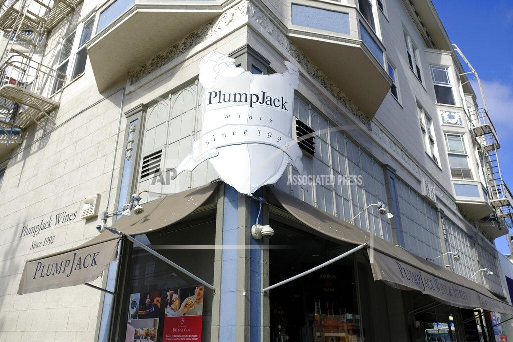 FILE - This Oct. 22, 2018, file photo shows the Plumpjack Wine & Spirits store in San Francisco, part of the Plumpjack Group collection of wineries, bars, restaurants, hotels and liquors stores. Companies affiliated with Gov. Gavin Newsom received nearly $3 million in loans designed to help small businesses survive the pandemic, more than eight times the amount originally reported, according to newly released information from the federal government. Nine businesses tied to Newsom's PlumpJack Group split the nearly $3 million in loans through the Small Business Administration's Paycheck Protection Program, according to new figures released last week. (AP Photo/Eric Risberg, File)