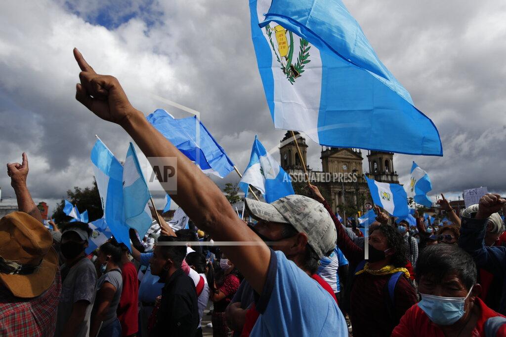 Moises Castillo Protesters gather outside Congress in Guatemala City, Saturday, Nov. 21, 2020. Hundreds of protesters were protesting in various parts of the country Saturday against Guatemalan President Alejandro Giammattei and members of Congress for the approval of the 2021 budget that reduced funds for education, health and the fight for human rights. (AP Photo/Moises Castillo)