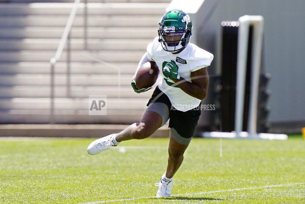 New York Jets wide receiver Elijah Moore carries the ball after catching a pass during an NFL football practice, Thursday, May 27, 2021, in Florham Park, N.J. (AP Photo/Kathy Willens)