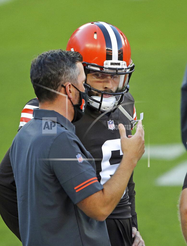 FILE - Cleveland Browns head coach Kevin Stefanski, left, talks to quarterback Baker Mayfield before an NFL football scrimmage at FirstEnergy Stadium in Cleveland, Friday, Sept. 4, 2020. The Browns will make their debut against the Cleveland Browns under first-year coach Kevin Stefanski, hired in January after Cleveland stumbled to a 6-10 record in 2019. The Browns are counting on Mayfield to bounce back, and his teammates have noticed his renewed commitment and focus. (Joshua Gunter/Cleveland.com via AP, File)