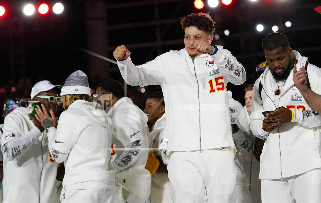 David J. Phillip Kansas City Chiefs Patrick Mahomes arrives with his teammates for Opening Night for the NFL Super Bowl 54 football game Monday, Jan. 27, 2020, at Marlins Park in Miami. (AP Photo/David J. Phillip)