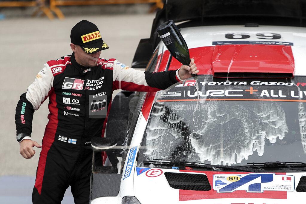 Klodian Lato Kalle Rovanpera's co-driver Jonne Halttunen of Finland celebrates after winning the WRC Acropolis Rally, near Lamia, northwest of Athens, Greece, Sunday, Sept. 12, 2021. The Finnish crew of Kalle Rovanpera and Jonne Halttunen has won the Acropolis Rally, after leading through most of the four-day World Rally Championship race. (Klodian Lato/Eurokinissi via AP)