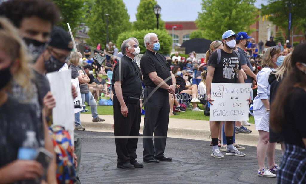John Starks Two priests stand in the crowd at a Black Lives Matter rally at the Peg Bond Pavilion in Batavia, Ill., Wednesday, June 3, 2020, during a protest over the death of George Floyd, a black man who was killed while in police custody in Minneapolis on May 25. (John Starks/Daily Herald via AP)