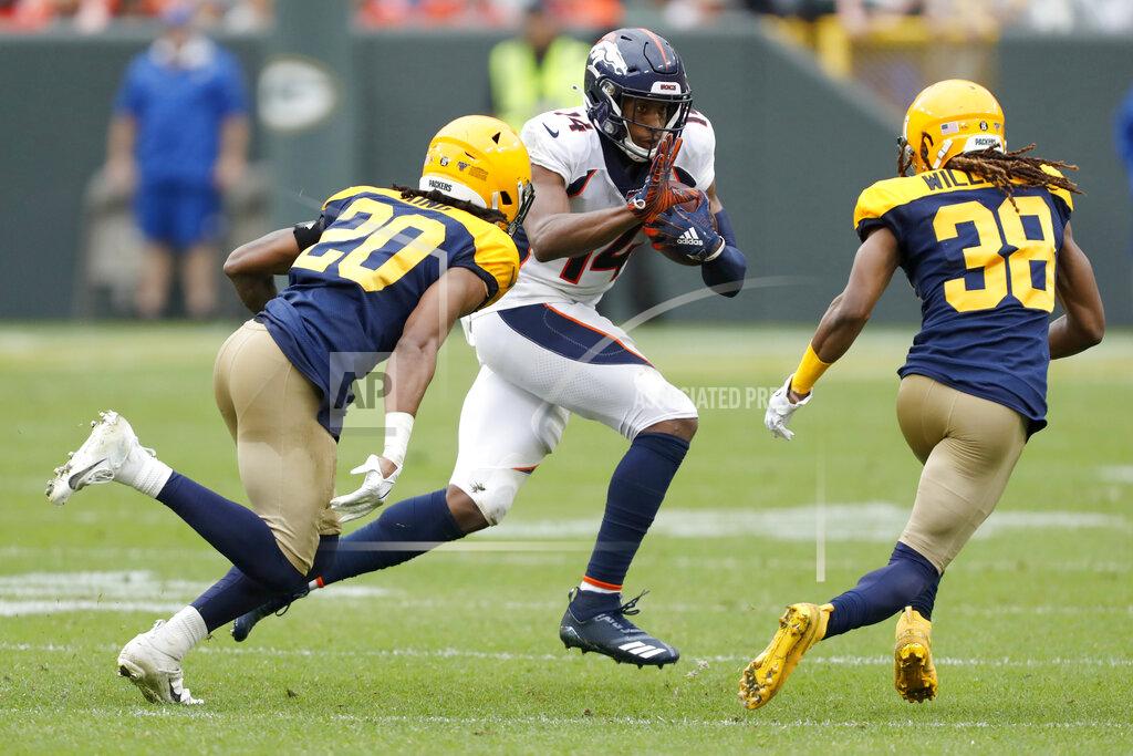 Matt Ludtke Denver Broncos wide receiver Courtland Sutton (14) runs with the ball as Green Bay Packers cornerbacks Kevin King (20) and Tramon Williams (38) defend during the second half of an NFL football game Sunday, Sept. 22, 2019, in Green Bay, Wis. (AP Photo/Matt Ludtke)
