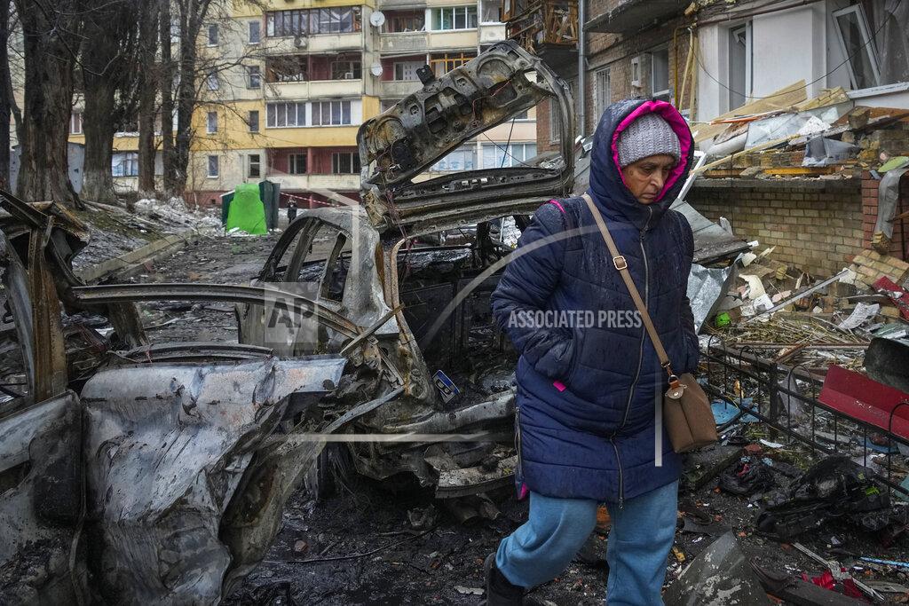 Efrem Lukatsky A woman walks by house damaged during Russian shelling in the town of Vyshgorod outside the capital Kiev, Ukraine, Thursday, Nov. 24, 2022. About 70% of the Ukrainian capital was left without power on Thursday morning after Moscow unleashed yet another devastating missile barrage on Ukraine's energy infrastructure, Kyiv's mayor said. (AP Photo/Efrem Lukatsky)