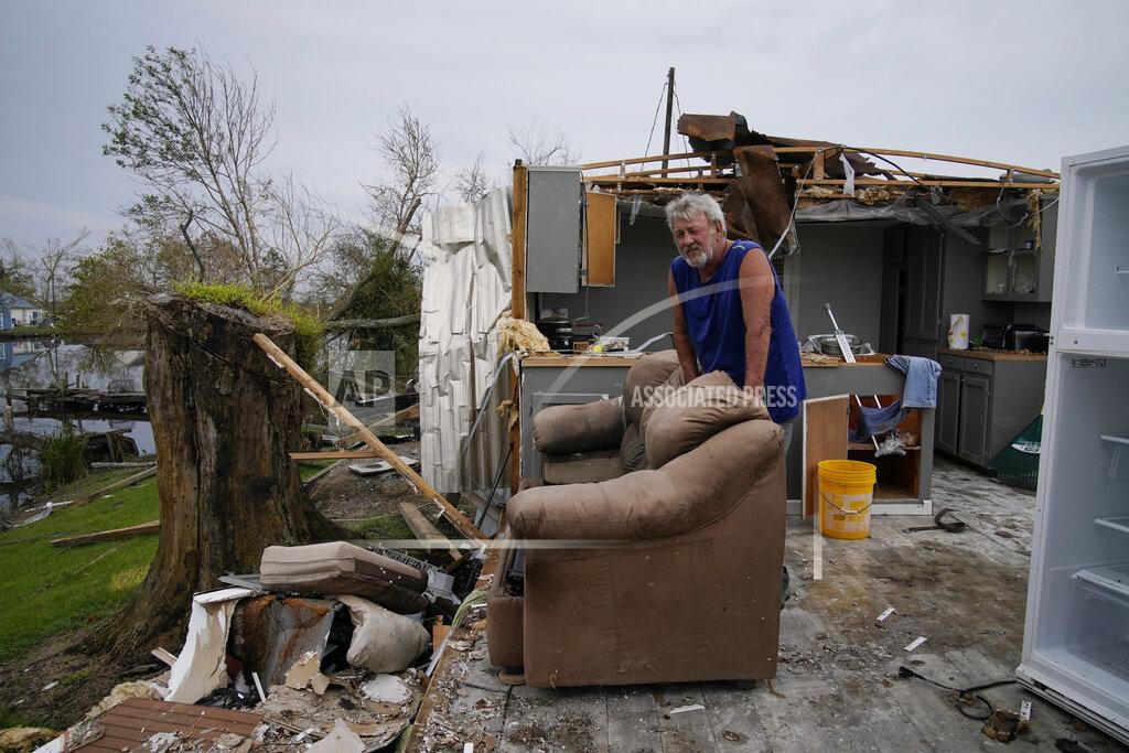 John Locher Philip Adams rests on his couch in what remains of his living room and kitchen at his hurricane destroyed home in the aftermath of Hurricane Ida, Monday, Sept. 6, 2021, in Lockport, La. (AP Photo/John Locher)