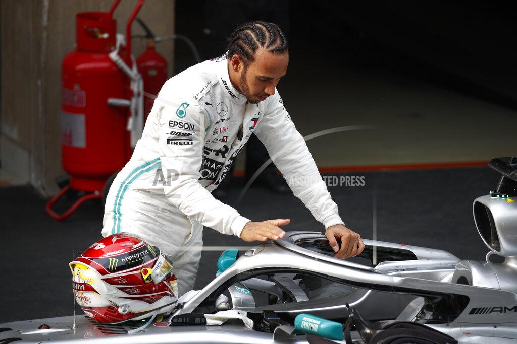 Andy Wong Mercedes driver Lewis Hamilton of Britain touches his car after winning the Chinese Formula One Grand Prix at the Shanghai International Circuit in Shanghai on Sunday, April 14, 2019. Vettel finished third. (AP Photo/Andy Wong)