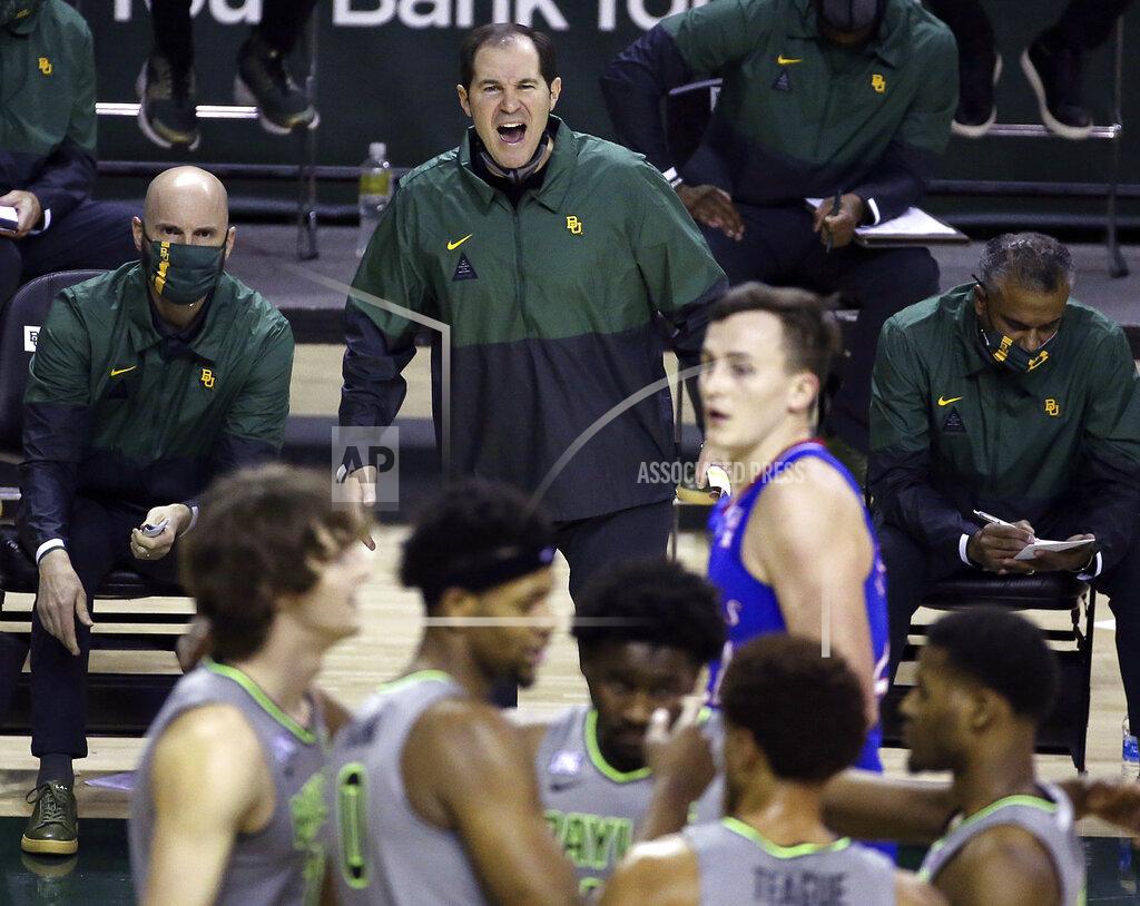 Jerry Larson File-Baylor head coach Scott Drew, top center, reacts to a play in the second half of an NCAA college basketball game against Kansas, Monday, Jan. 18, 2021, in Waco, Texas. “You get to spend the entire year helping your game get better without the outside pressure or having to worry about being ready for each and every game, so it’s truly one year of development,” Drew said of redshirts, for current players and Bears in the past decade who went on to play professionally. (AP Photo/Jerry Larson, File)