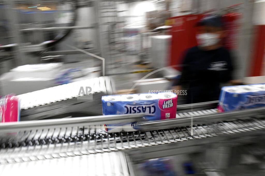 Tamas Kovacs A worker checks the toilet paper rolls on a conveyor belt at a plant of Vajda-Papir Ltd in Budapest, Hungary, Friday, April 17, 2020. The Hungarian-owned company is able to provide its partners with enormous production capacity in all product categories as its annual base paper production far exceeds domestic needs, therefore Hungary can even be self-sufficient in these products despite the increased demand due to the ongoing pandemic of the COVID-19 disease caused by the SARS-CoV-2 coronavirus. (Tamas Kovacs/MTI via AP)