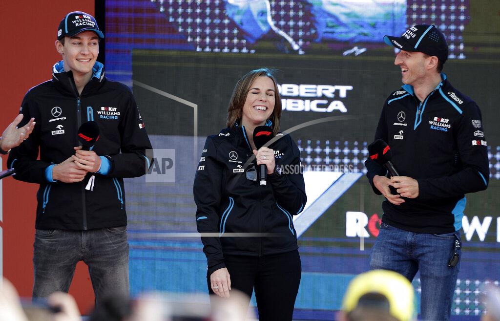 Williams driver Robert Kubica of Poland, right, and teammate George Russell of Britain, laugh with team principal Williams team principal Claire Williams during the launch for the Australian Grand Prix in Melbourne, Australia, Wednesday, March 13, 2019. (AP Photo/Rick Rycroft)