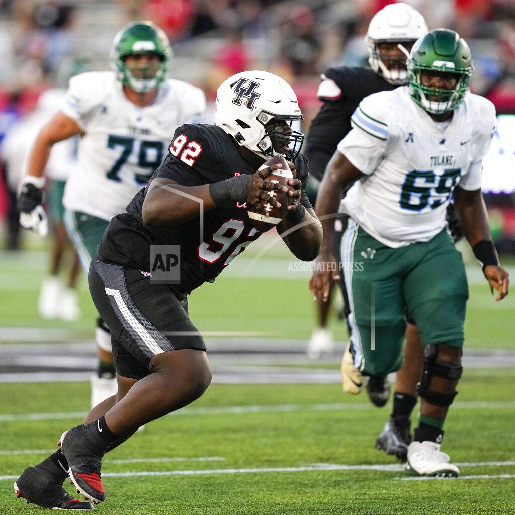 Brett Coomer Houston defensive lineman Hakeem Ajijolaiya (92) picks up a fumble by Tulane quarterback Kai Horton during the second quarter of an NCAA college football game Friday, Sept. 30, 2022, in Houston. (Brett Coomer/Houston Chronicle via AP)