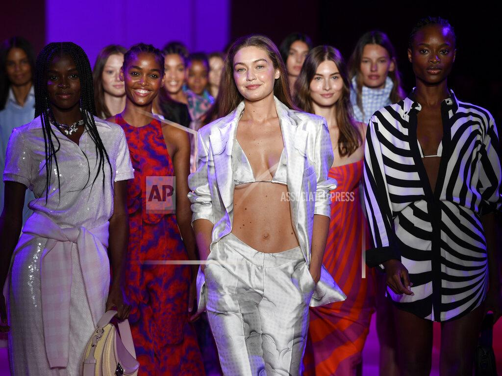 Evan Agostini Models, including Gigi Hadid, center, walk the runway during the finale at the Brandon Maxwell spring/summer 2022 fashion show in the Brooklyn borough of New York during Fashion Week on Friday, Sept. 10, 2021. (Photo by Evan Agostini/Invision/AP)