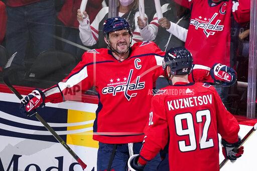 Washington Capitals left wing Alex Ovechkin (8) celebrates his first goal of the third period with center Evgeny Kuznetsov in an NHL hockey game, Wednesday, Oct. 13, 2021, in Washington. The Capitals won 5-1. (AP Photo/Alex Brandon)