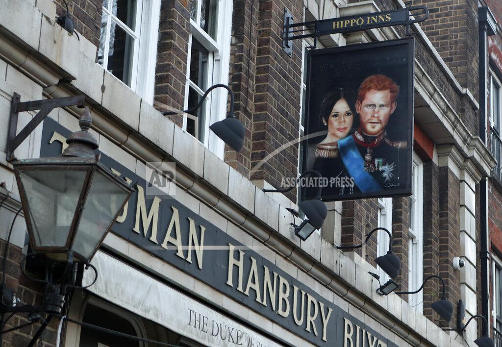 Tony Hicks A sign showing Britain's Prince Harry and his wife Meghan, hangs outside the Duke of Sussex pub near Waterloo station, London, Tuesday March 9, 2021. Prince Harry and Meghan's explosive TV interview has divided people around the world, rocking an institution that is struggling to modernize with claims of racism and callousness toward a woman struggling with suicidal thoughts. (AP Photo/Tony Hicks)