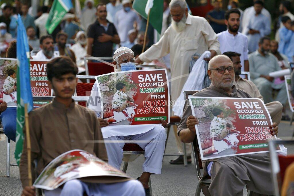 Anjum Naveed Supporters of a religious group Jamaat-e-Islami take part in a rally to show solidarity with Kashmiri people on the eve of first anniversary of India's decision to revoke the disputed region's semi-autonomy, in Islamabad, Pakistan, Wednesday, Aug. 5, 2020. Last year on Aug. 5, India's Hindu-nationalist-led government of Prime Minister Narendra Modi stripped Jammu and Kashmir's statehood, scrapped its separate constitution and removed inherited protections on land and jobs. (AP Photo/Anjum Naveed)